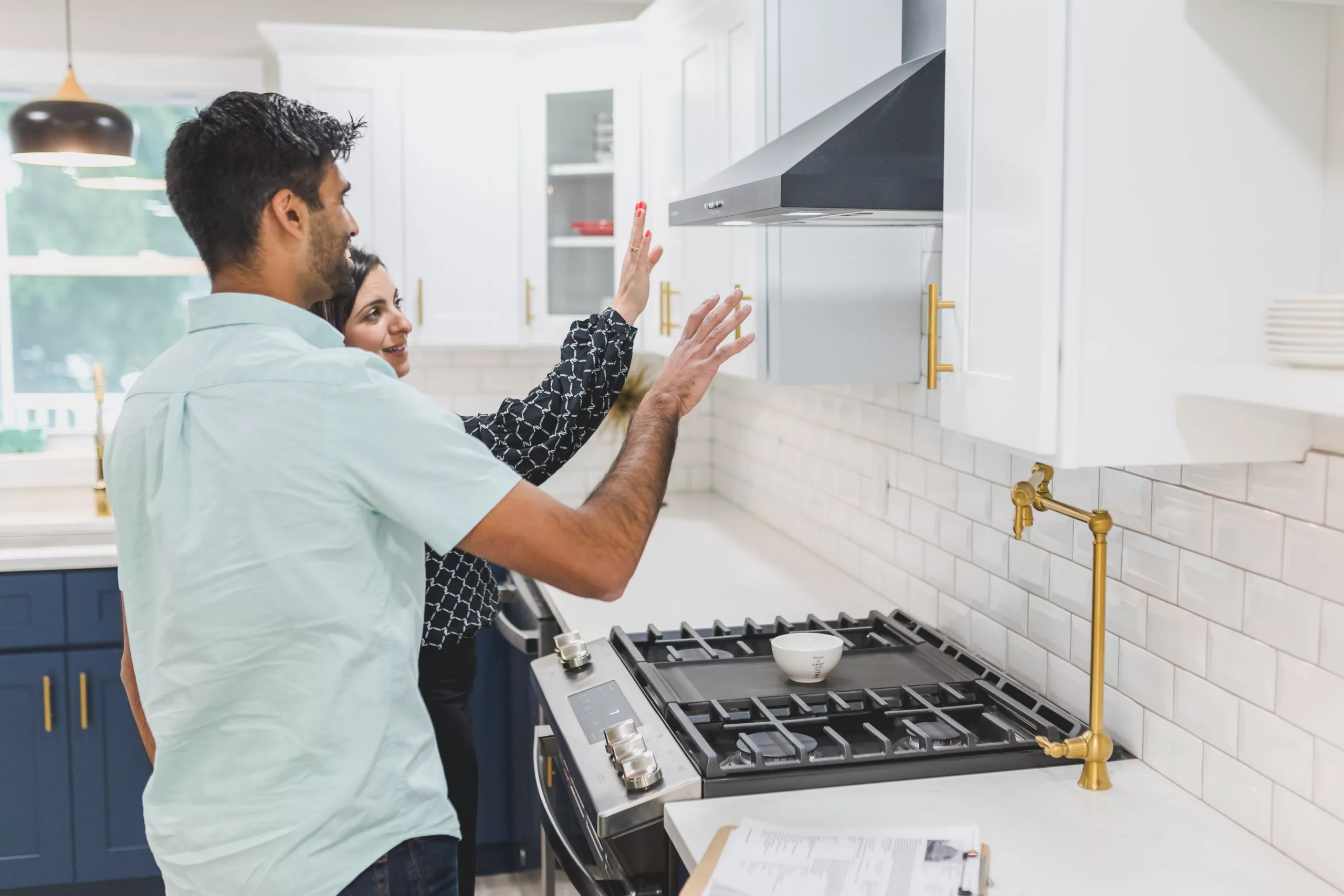 2 people looking at oven range